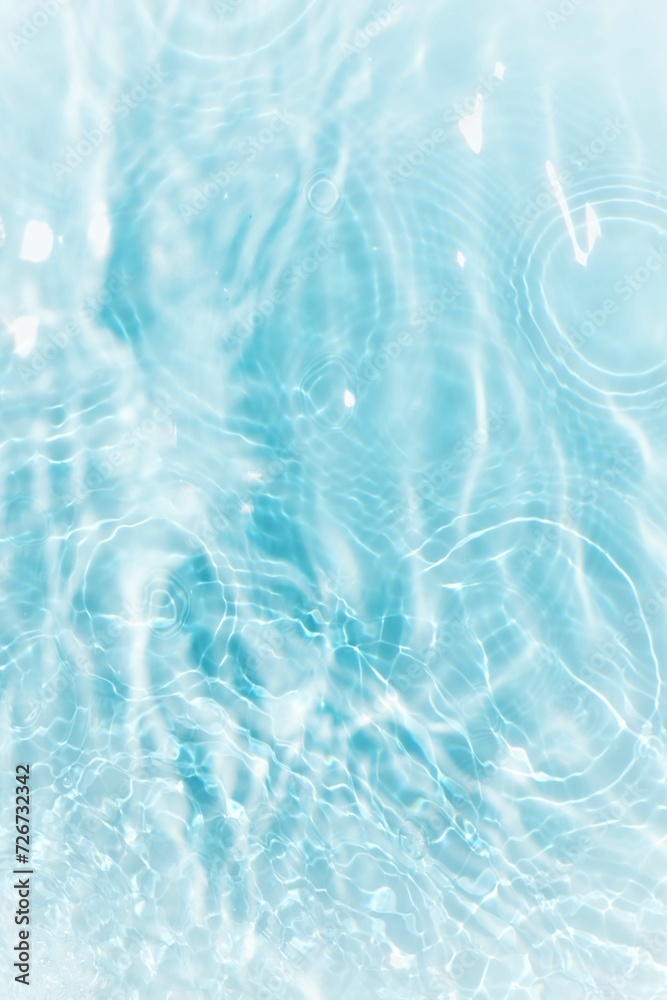 Water surface. Bluewater waves on the surface ripples blurred. Defocus blurred transparent blue colored clear calm water surface texture with splash and bubbles. Water waves with shining pattern. Water surface. Bluewater waves on the surface ripples blurred. Defocus blurred transparent blue colored clear calm water surface texture with splash and bubbles. Water waves with shining pattern.