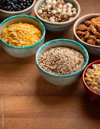 Top view of some bowls with different types of cereals inside. The cereal industry and National Cereal Day History. Copy Space. © Patrick