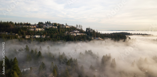 Residential Homes on top of mountain with fog. Sunset.