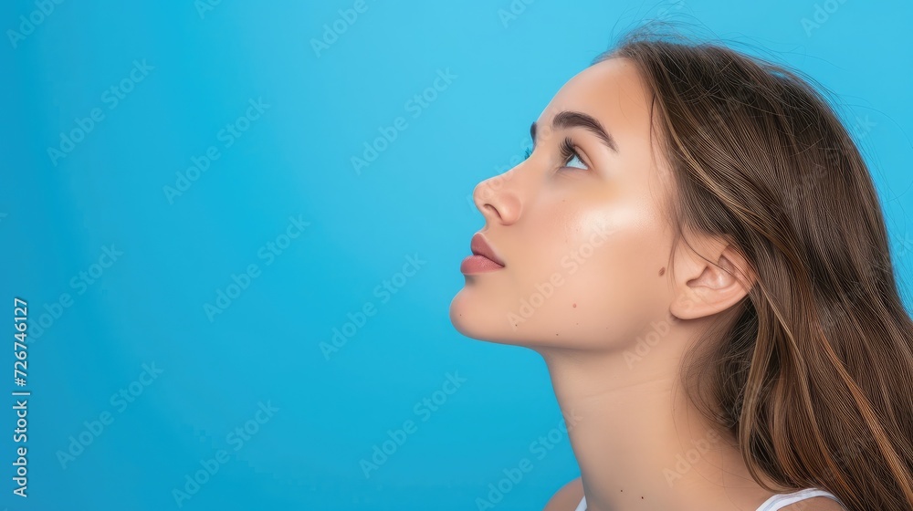 Profile side view portrait of attractive cheerful girl demonstrating copy space ad new isolated over bright blue color background Profile side view portrait of attractive cheerful girl demonstrating copy space ad new isolated over bright blue color background