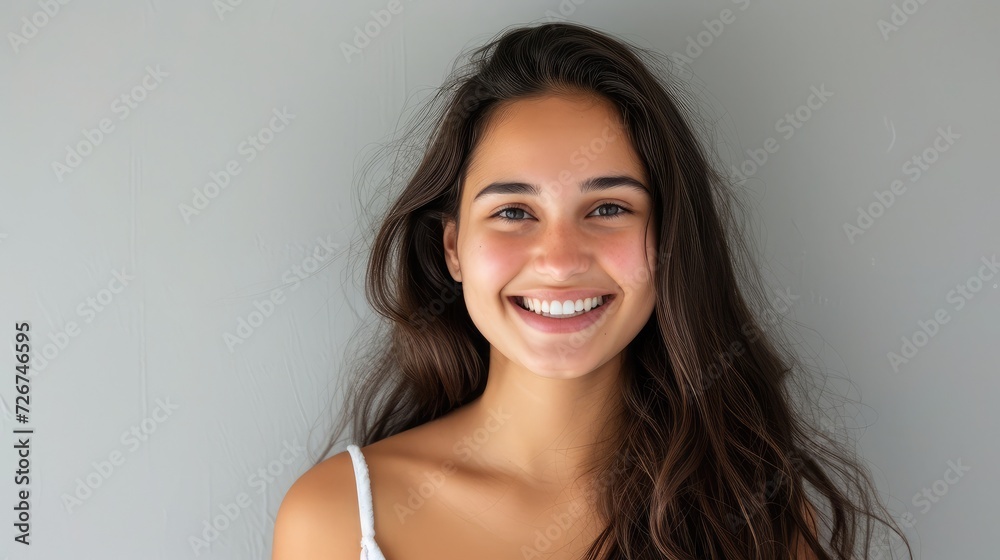 young woman with beautiful smile isolated on grey wall with copy space. Successful multiethnic girl. Latin woman looking at camera against gray wall with a big whitening teeth smile young woman with beautiful smile isolated on grey wall with copy space. Successful multiethnic girl. Latin woman looking at camera against gray wall with a big whitening teeth smile
