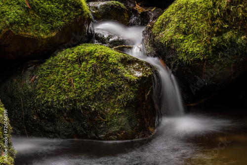 Long-exposure photograph of the stream and mossy rocks of a creek in the hillside of the Iguaque mountain  in the eastern central Andes of Colombia.