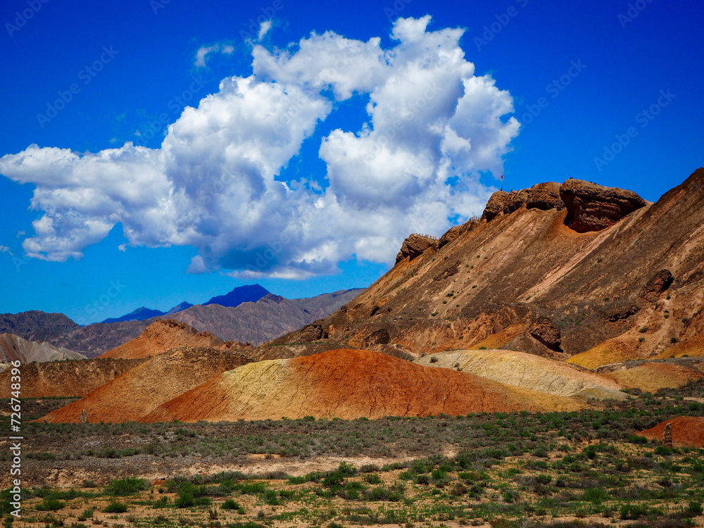 Colourful rocks and peak with cloud hanging over the mountains Colourful rocks and peak with cloud hanging over the mountains
