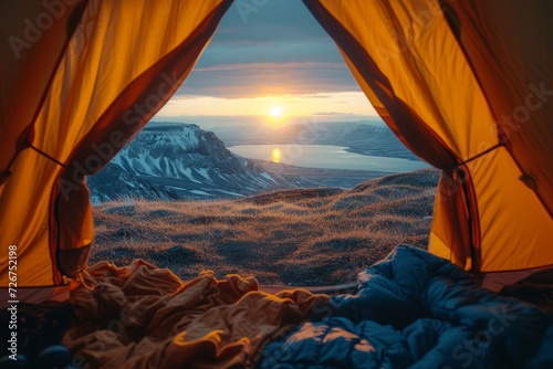 Embracing the beauty of nature, a tarpaulin-clad tent provides the perfect vantage point for a breathtaking sunset and sunrise over the majestic mountains in this picturesque outdoor landscape