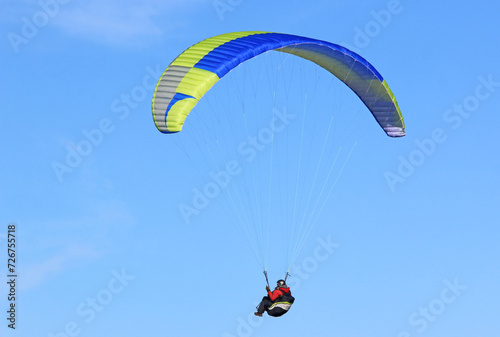 Paraglider flying in a blue sky 