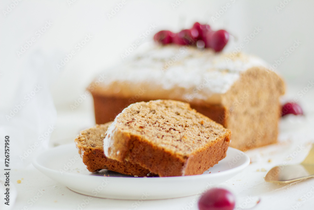 Homemade nut cake with cherrys on white background. Aesthetic breakfast concept. Homemade nut cake with cherrys on white background. Aesthetic breakfast concept.