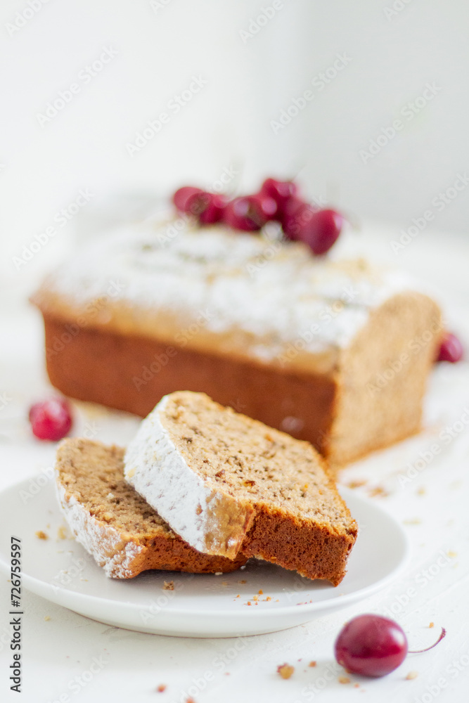 Homemade nut cake with cherrys on white background. Aesthetic breakfast concept. Homemade nut cake with cherrys on white background. Aesthetic breakfast concept.