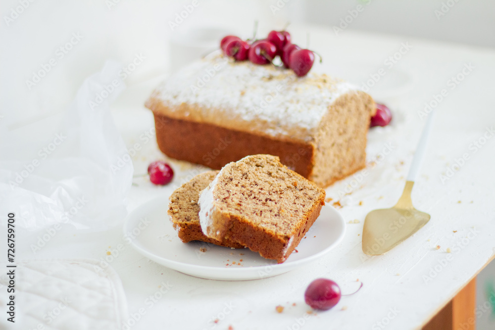 Homemade nut cake with cherrys on white background. Aesthetic breakfast concept. Homemade nut cake with cherrys on white background. Aesthetic breakfast concept.