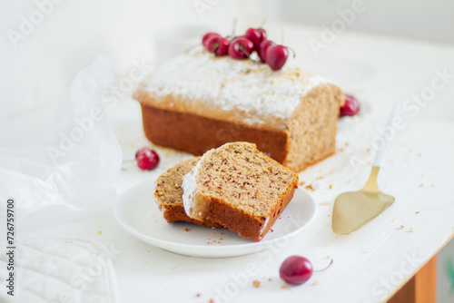 Homemade nut cake with cherrys on white background. Aesthetic breakfast concept.