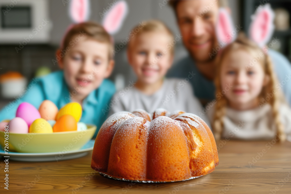 Fototapeta premium Traditional Easter cake and eggs with father and children