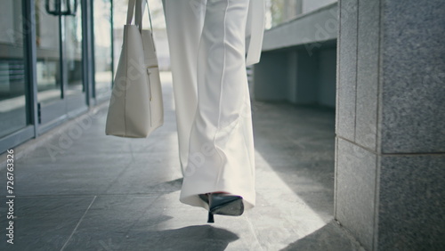 Stylish woman legs walking office in high heels closeup. Girl feet going on work photo