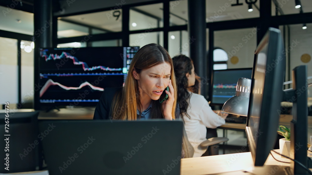 Stressed businesswoman argue call in finance corporation. Nervous trader talking Stressed businesswoman argue call in finance corporation. Nervous trader talking