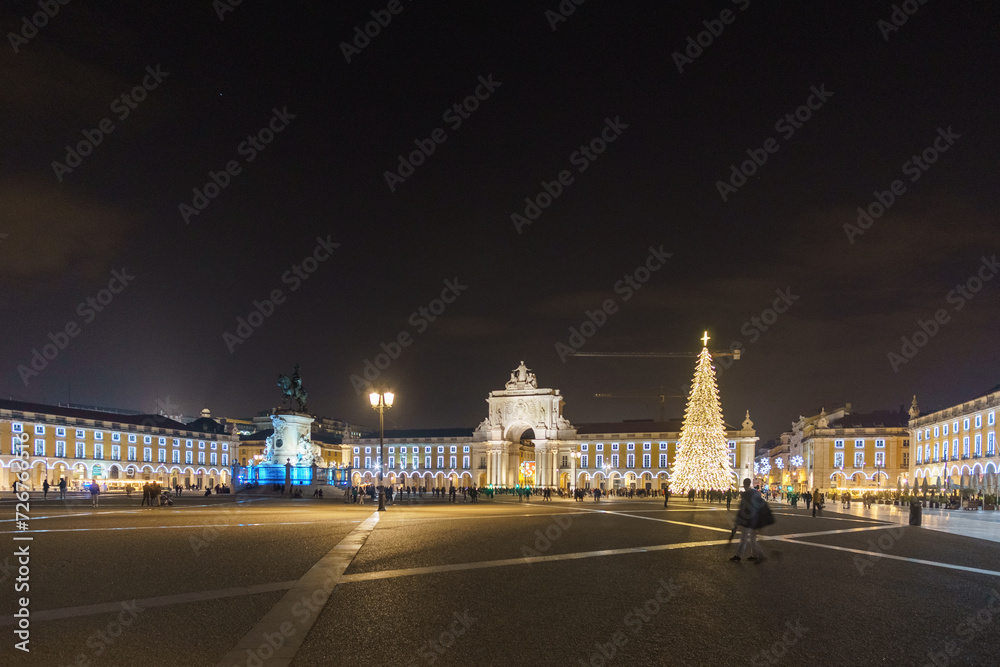 Praca do Comercio in portuguese capital during christmas time in the night with illumination and christmas tree, Lisbon, Portugal