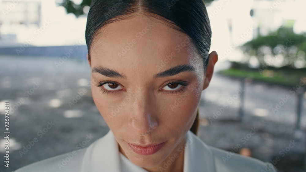 Closeup beautiful woman face with confident gaze outdoors. Elegant businesswoman Closeup beautiful woman face with confident gaze outdoors. Elegant businesswoman