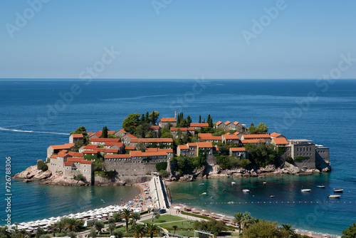 View of the island of St. Stephen at sunny day, Montenegro. Aman Sveti Stefan for publication, poster, screensaver, wallpaper, postcard, banner, cover, post. High quality photo