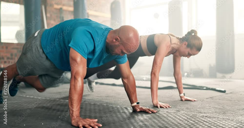 Couple, fitness and mountain climber exercise at gym on floor for workout or training together. Active man and woman, personal trainer or coach for abs, core strength or endurance at health club