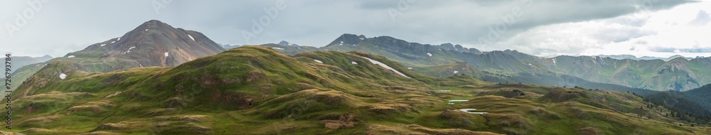 Summer mountain panorama in the tundra with sun rays