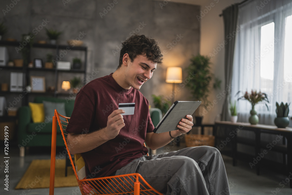 teenager young man sit at home use credit card shopping online teenager young man sit at home use credit card shopping online