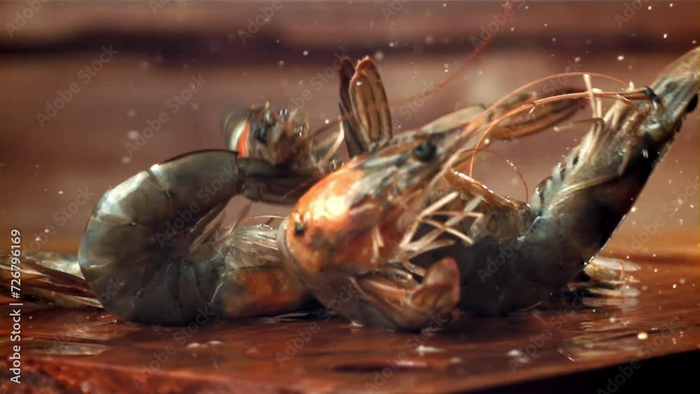 The shrimp falls on a wooden cutting board. Filmed on a high-speed camera at 1000 fps. High quality FullHD footage The shrimp falls on a wooden cutting board. Filmed on a high-speed camera at 1000 fps. High quality FullHD footage