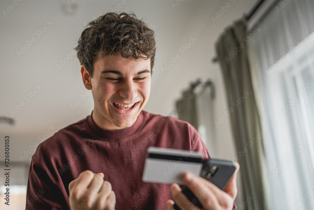 teenager young man sit at home use credit card shopping online teenager young man sit at home use credit card shopping online