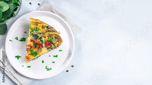 Piece of brunch egg frittata with vegetables on plate, horizontal, top view, copy space photo