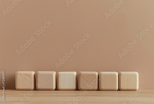 Six wooden blocks in a row up against a wall, presented in the style of light amber and beige, color gradients, minimalist photography, and toy-like proportions. photo