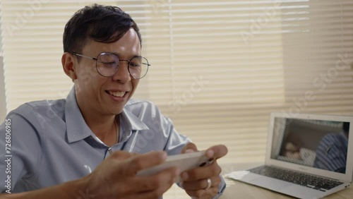 Man playing games on mobile phone with fun, Enjoy playing games on your smartphone, Happy time.