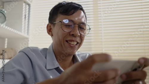Man playing games on mobile phone with fun, Enjoy playing games on your smartphone, Happy time.