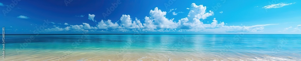 Panoramic beach landscape with the sky meeting the ocean water and a sandy deserted beach Panoramic beach landscape with the sky meeting the ocean water and a sandy deserted beach