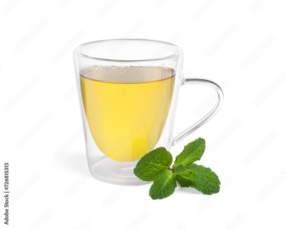 Fresh green tea in glass mug and mint isolated on white Fresh green tea in glass mug and mint isolated on white