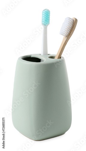 Bath accessory. Ceramic holder with toothbrushes isolated on white