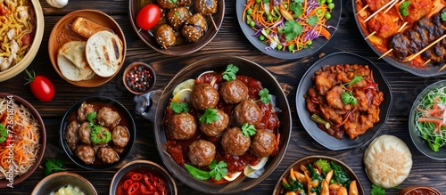 Belgian meatball in tomato sauce and a variety of traditional Asian dishes viewed from the top. photo