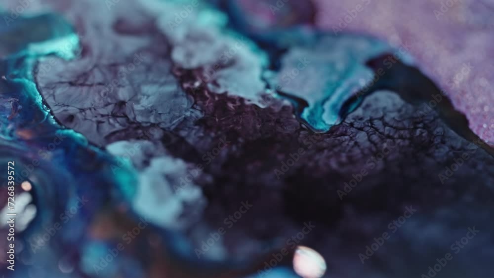 Close-up of vibrant blue and purple ink diffusing in water, creating an abstract pattern Close-up of vibrant blue and purple ink diffusing in water, creating an abstract pattern