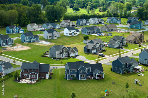 American dream homes as example of real estate development in US suburbs. View from above of residential houses in living area in Rochester, NY