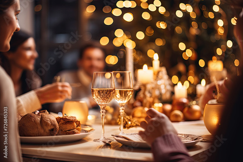 people are enjoying holiday food at table with glasses next to them, in the style of back button focus, light gold and dark beige, xmaspunk, pigeoncore, whirring contrivances, humanistic empathy photo