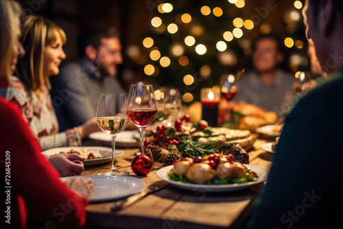 people are enjoying holiday food at table with glasses next to them  in the style of back button focus  light gold and dark beige  xmaspunk  pigeoncore  whirring contrivances  humanistic empathy