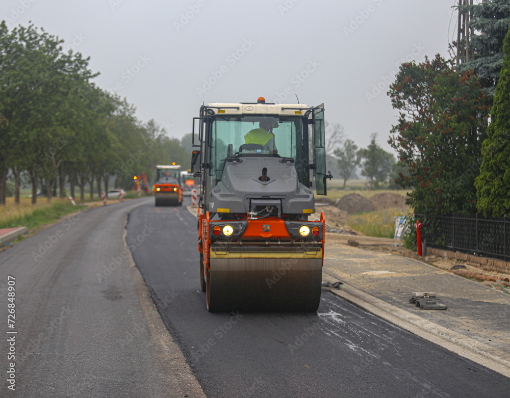 Vibratory asphalt rollers compactor compacting new asphalt pavement. Road service build a new highway
Vibratory asphalt rollers compactor compacting new asphalt pavement. Road service build a new highway
