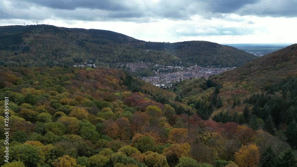 Push in drone shot of Heidelberg, shot from above autumn forest. With the Neckar River in shot as well as the town and Heidelberg Palace. 4K Shot in Autumn, Germany Push in drone shot of Heidelberg, shot from above autumn forest. With the Neckar River in shot as well as the town and Heidelberg Palace. 4K Shot in Autumn, Germany