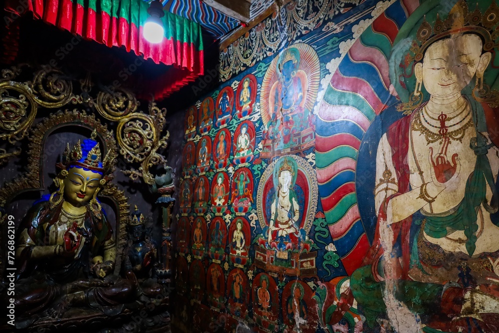 Explore the tranquil beauty of Kumbum Stupa's chapels, adorned with ancient Buddhist statues and vibrant Tibetan murals at Palcho Monastery in Gyantse, Tibet.