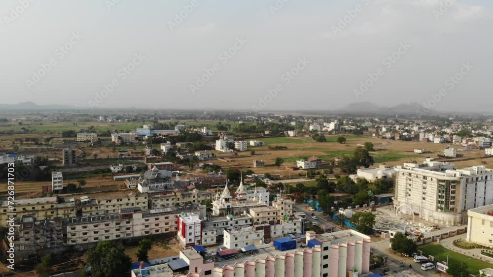 Backward aerial view of a Monastery during afternoon in Gaya, Bihar with cityscape at background. Backward aerial view of a Monastery during afternoon in Gaya, Bihar with cityscape at background.