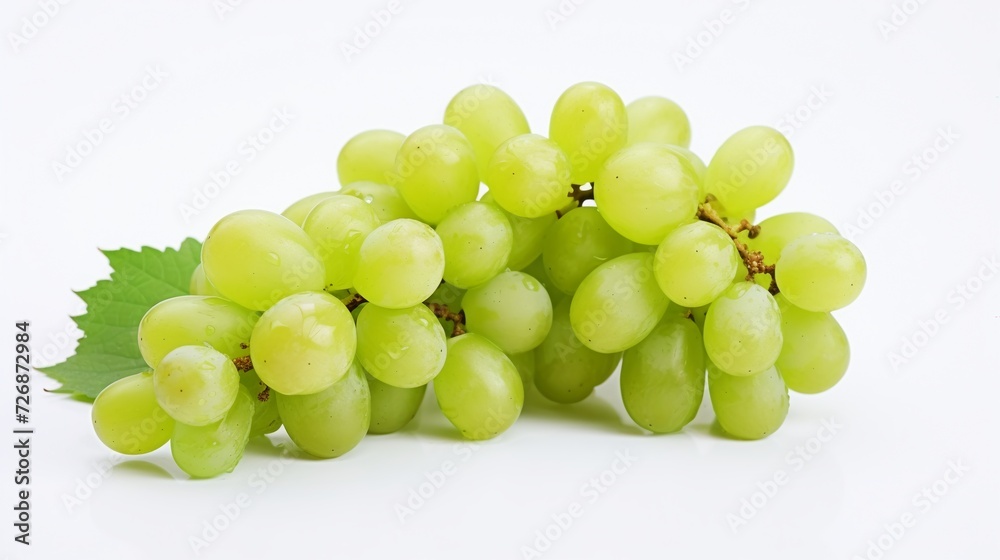 Bunch of green grapes with leaves isolated on a white background.