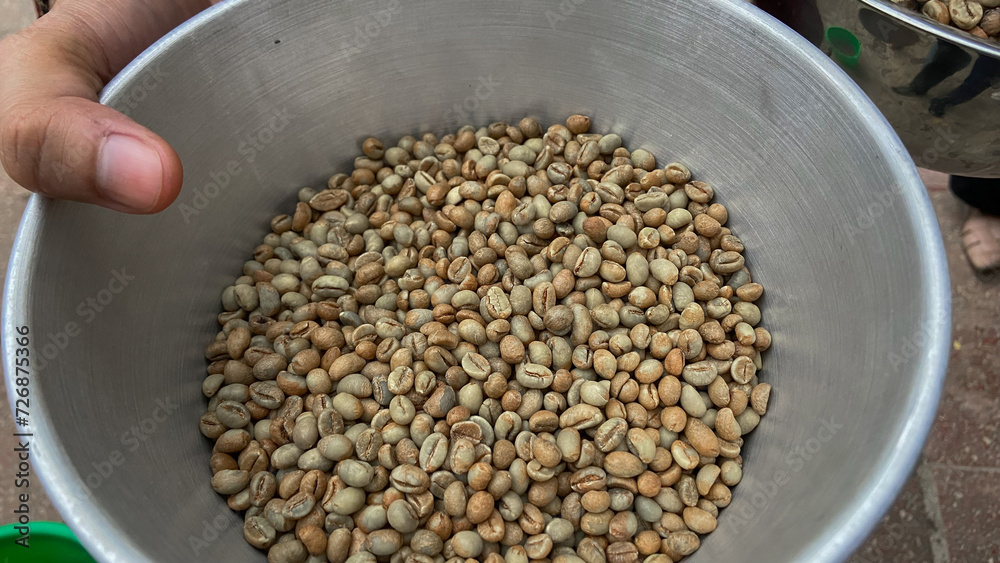 Banyuwangi coffee beans. Coffee beans are spread out on the surface. Robusta coffee beans on a drying place Banyuwangi coffee beans. Coffee beans are spread out on the surface. Robusta coffee beans on a drying place