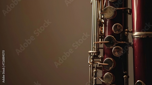 Close-Up View of a Dark Red Bassoon with Silver Keys Highlighted Against a Softly Lit Background photo