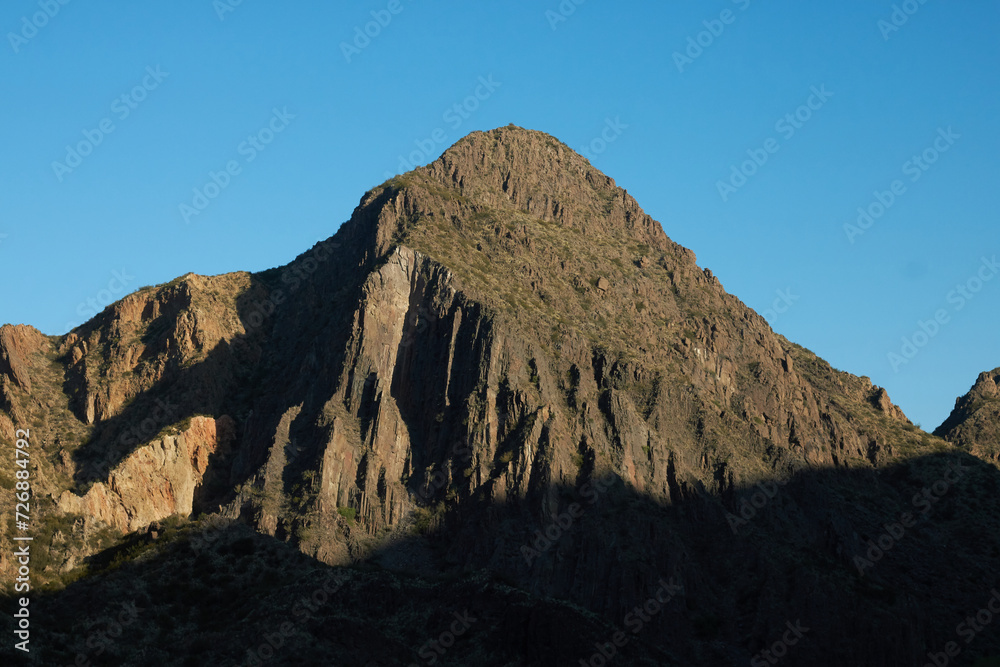 view of the top of a mountain with a harsh contrast by sunlight