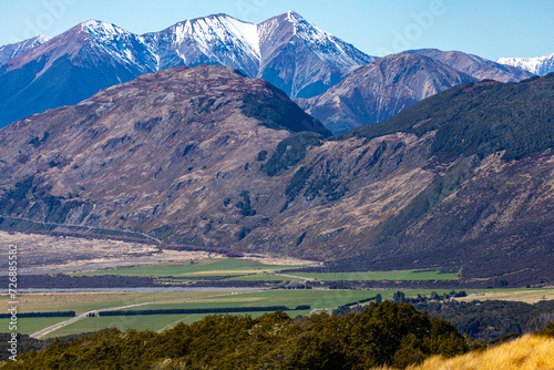 spring panorama of mountains in artur's pass national park, canterbury, new zealand; waimakariri river valley surrounded with massive, snow-capped mountains seen from bealey spur track