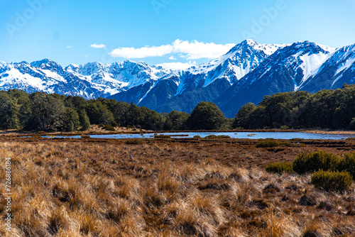 spring panorama of mountains in artur's pass national park, canterbury, new zealand; waimakariri river valley surrounded with massive, snow-capped mountains seen from bealey spur track photo