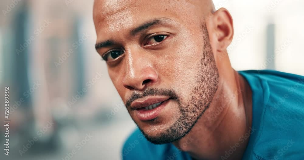 Face, fitness and breathing with man in gym to rest from workout for health or cardio. Portrait, exercise and sweating with exhausted young athlete training for intensity, performance or improvement