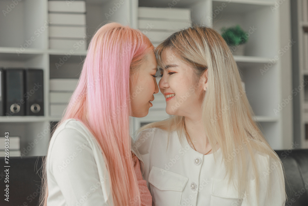 LGBT lesbian couple love moments happiness concept, Smiling young lesbian couple, lesbian couple embracing in the living room, Female couple enjoying time together in the house. LGBT lesbian couple love moments happiness concept, Smiling young lesbian couple, lesbian couple embracing in the living room, Female couple enjoying time together in the house.