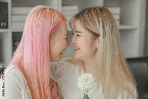LGBT lesbian couple love moments happiness concept, Smiling young lesbian couple, lesbian couple embracing in the living room, Female couple enjoying time together in the house.