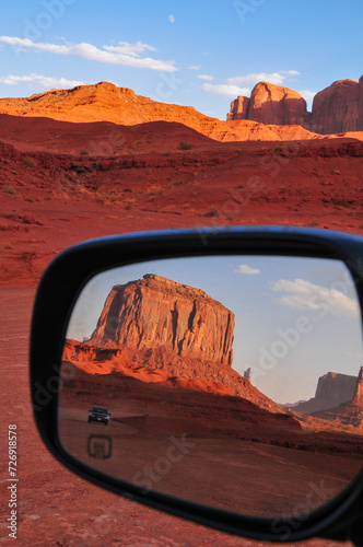 Sandstone buttes on a rear view mirror on the Scenic Drive of Monument Valley Navajo Tribal Park, Arizona, Southwest USA.
